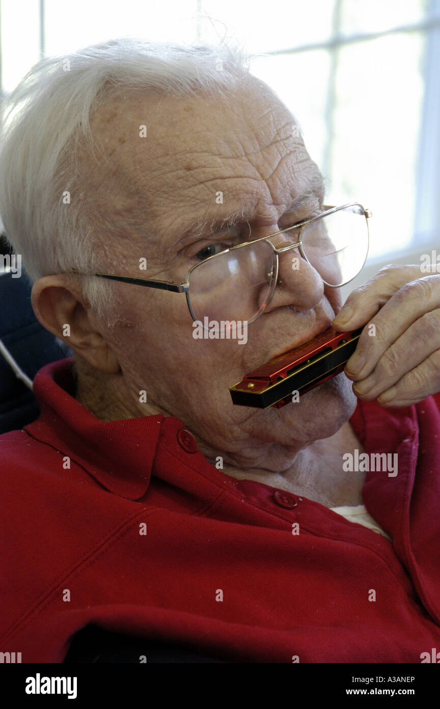 Elderly man playing harmonica hi-res stock photography and images - Alamy