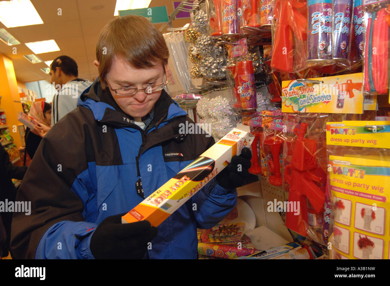 A young man with Downs Syndrome goes shopping with his carer for a