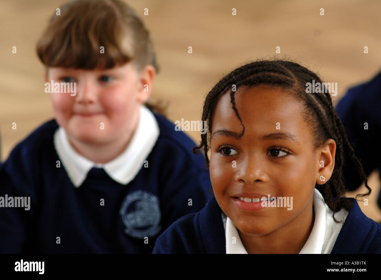 Mixed group of primary school children join in a group discussion West