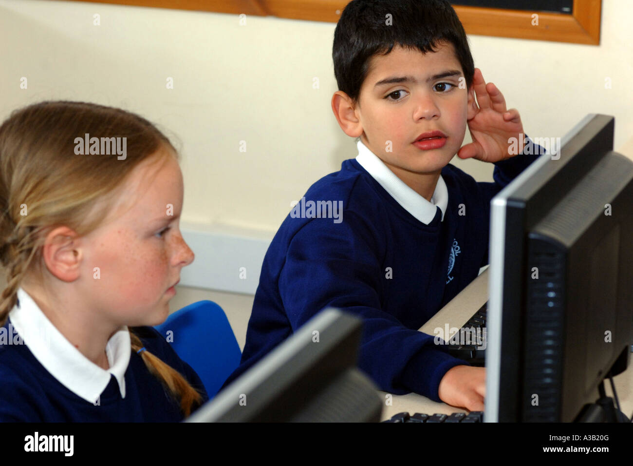 Primary school children use a computer in the IT Suite Stock Photo