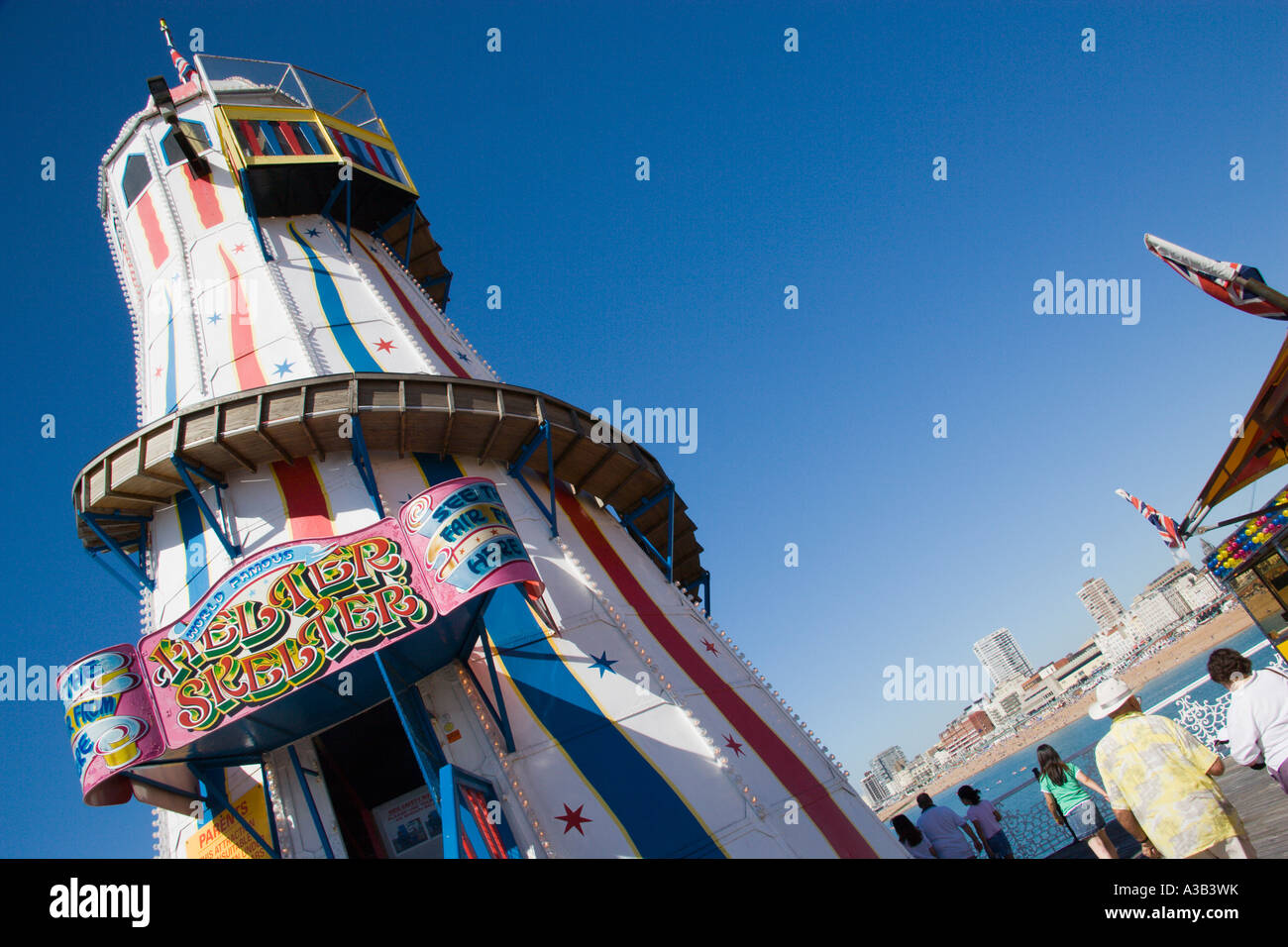 ENGLAND East Sussex Brighton Pier Helter Skelter Ride with tourists looking at south coast seaside resort city and beach beyond Stock Photo