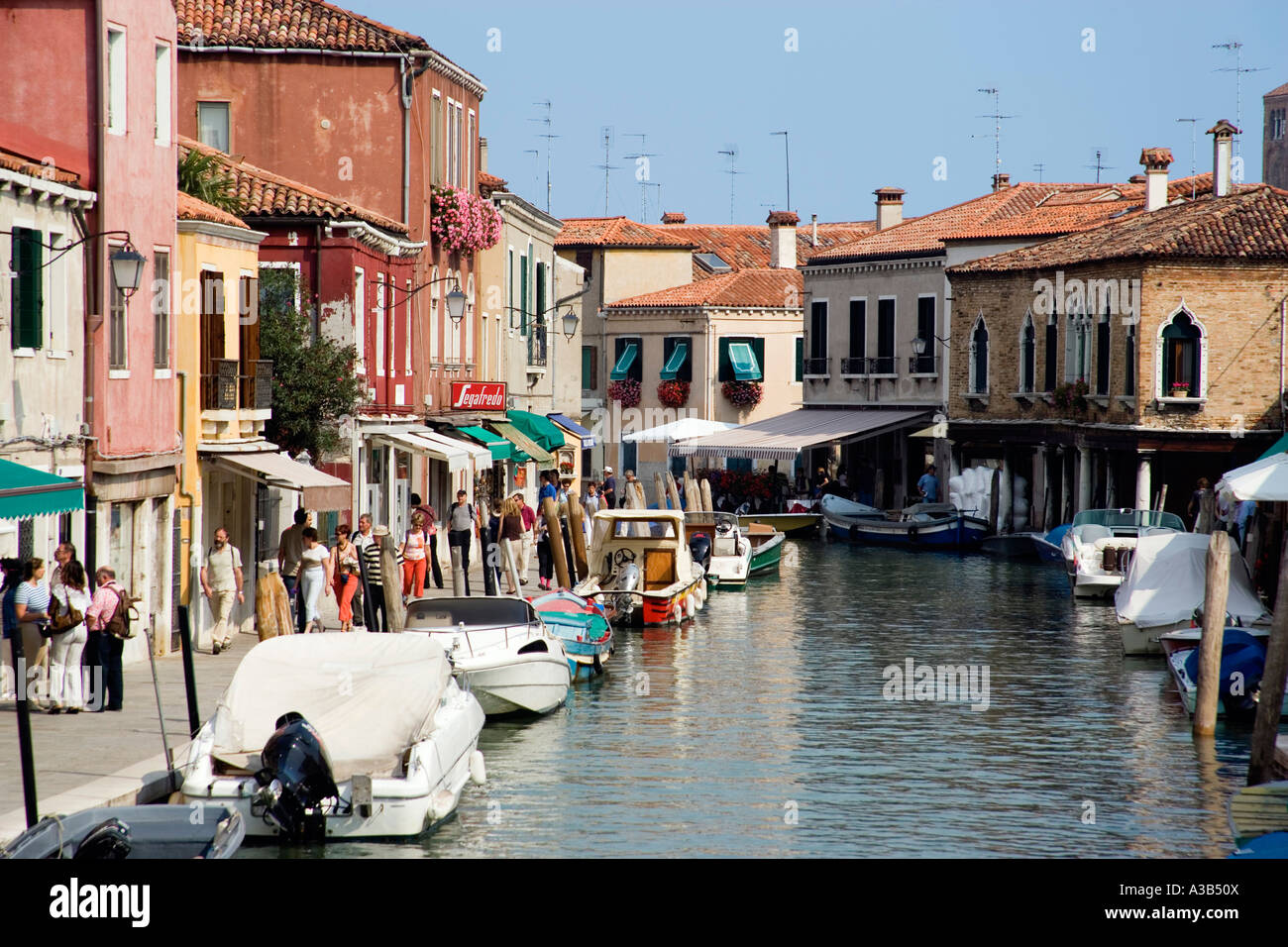 ITALY Veneto Venice Tourists walking beside main canal on Fondamente dei Vetrai on glass making Lagoon Island of Murano Stock Photo