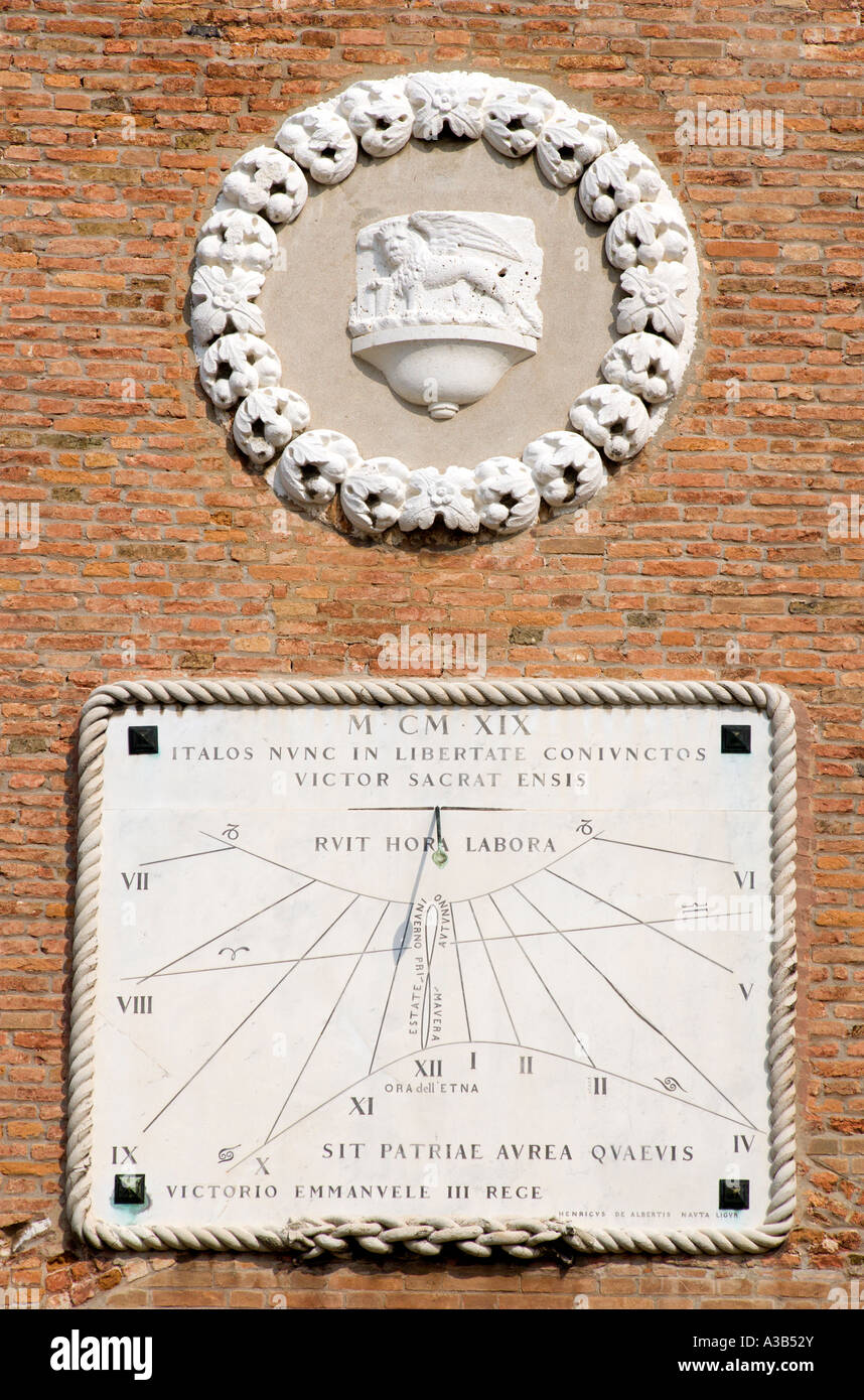 ITALY Veneto Venice Sundial on wall of Arsenal Naval dockyard with words written in Latin Language and Winged Lion of St Mark Stock Photo