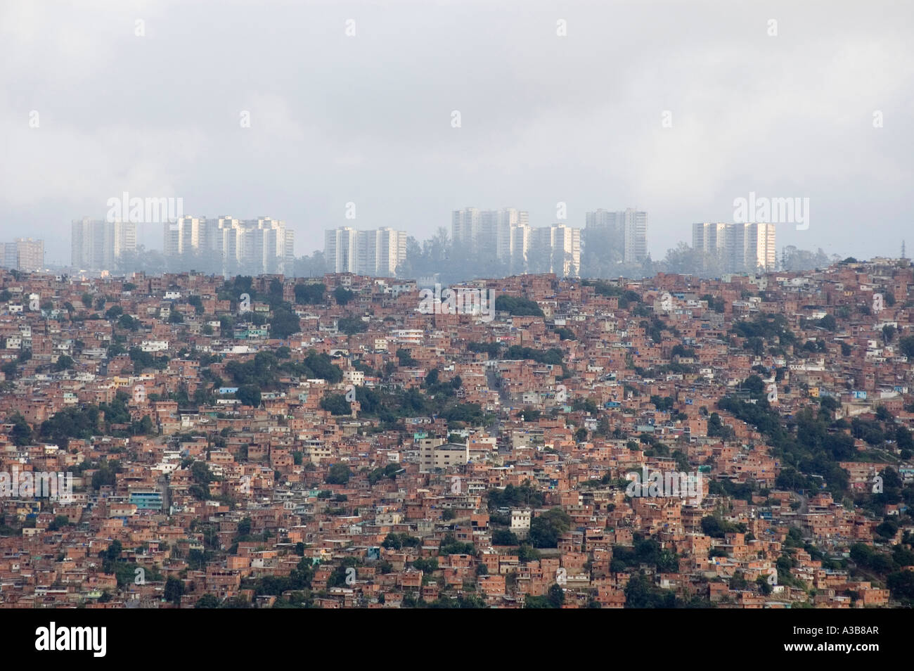 VENEZUELA South America Caracas High rise buildings of capital city shrouded in pollution with slum housing in foreground Stock Photo