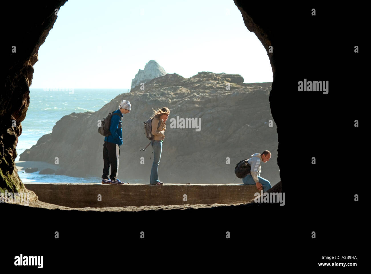 Tourists exploring a cave near a beach in San Francisco California USA Stock Photo