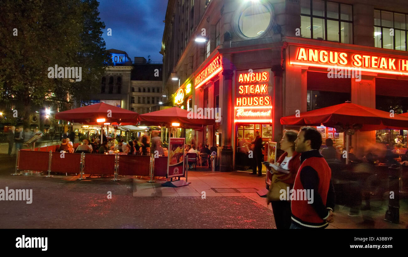 Open air terrace tables outside the Angus Steak House Leicester Square London Stock Photo