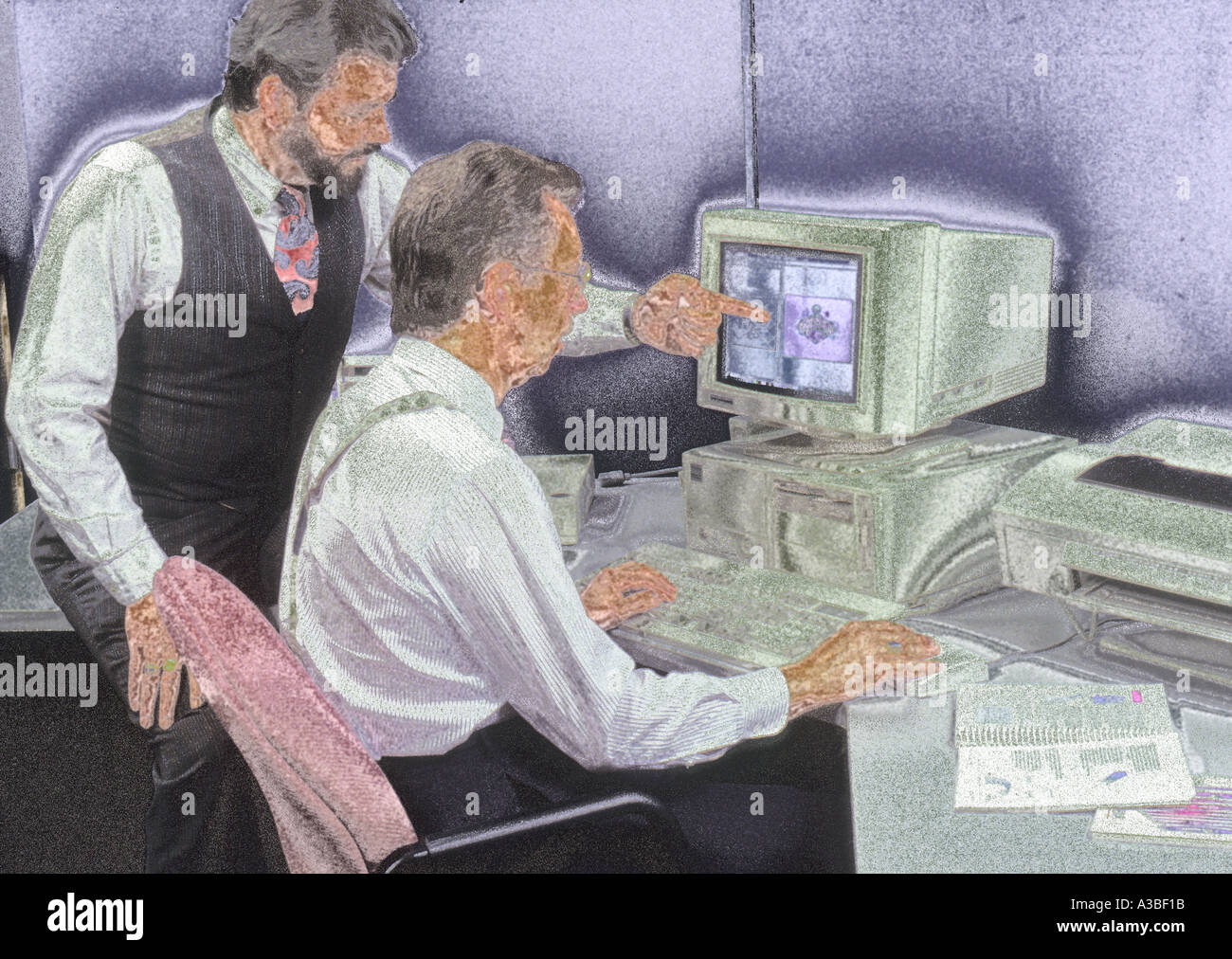 Two businessmen working on computer together Stock Photo