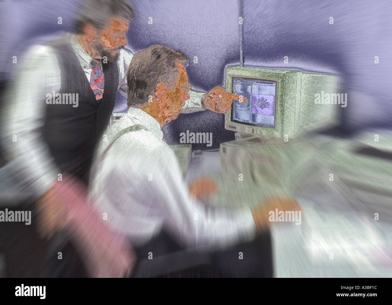 Two businessmen working on computer together Stock Photo