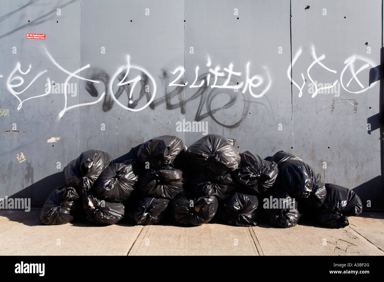 Stacked up trash bags on the sidewalk Stock Photo Alamy