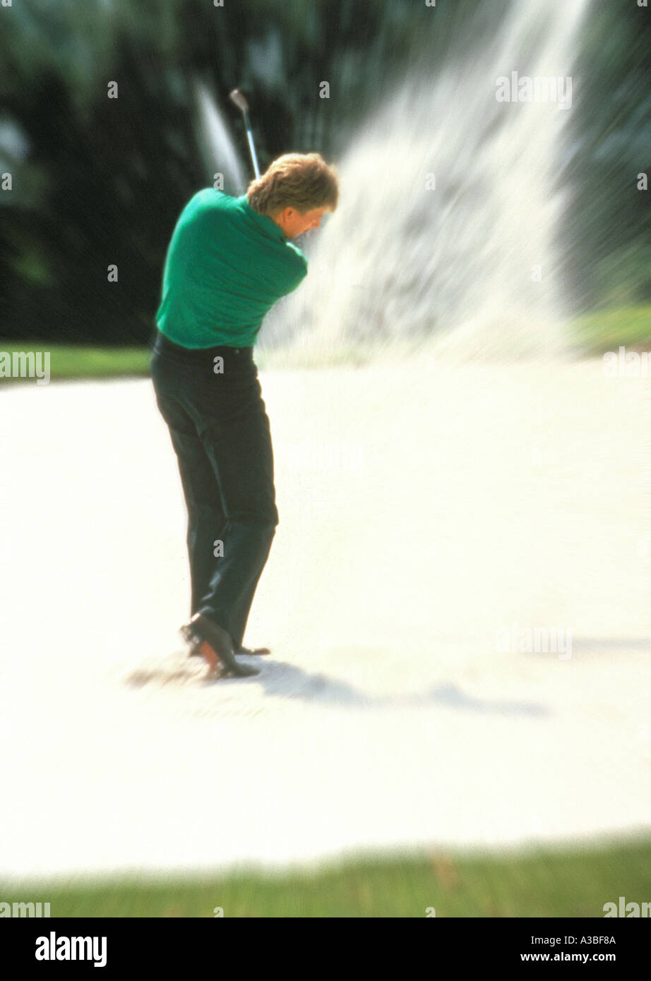 Action Man hitting golf ball out of sand trap Stock Photo Alamy