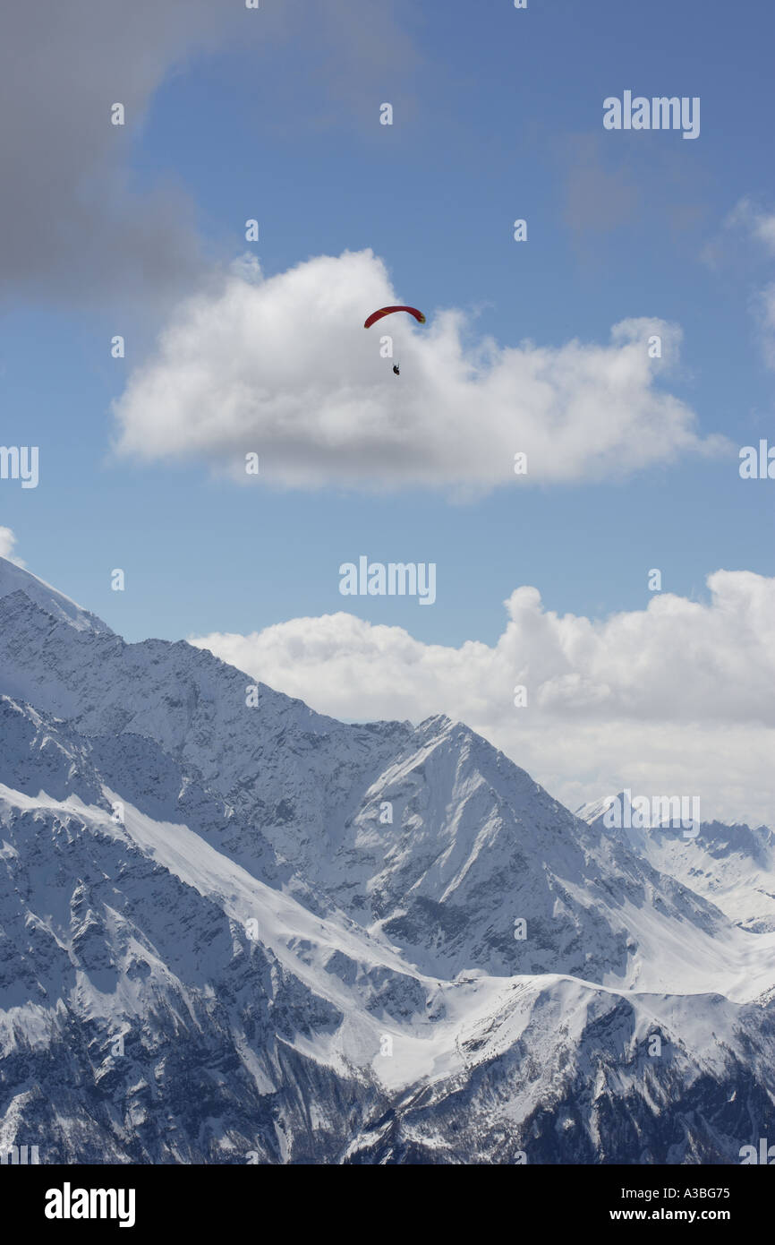 Paraglider in the sky. Parafoil harness and hanging rider. Stock Photo
