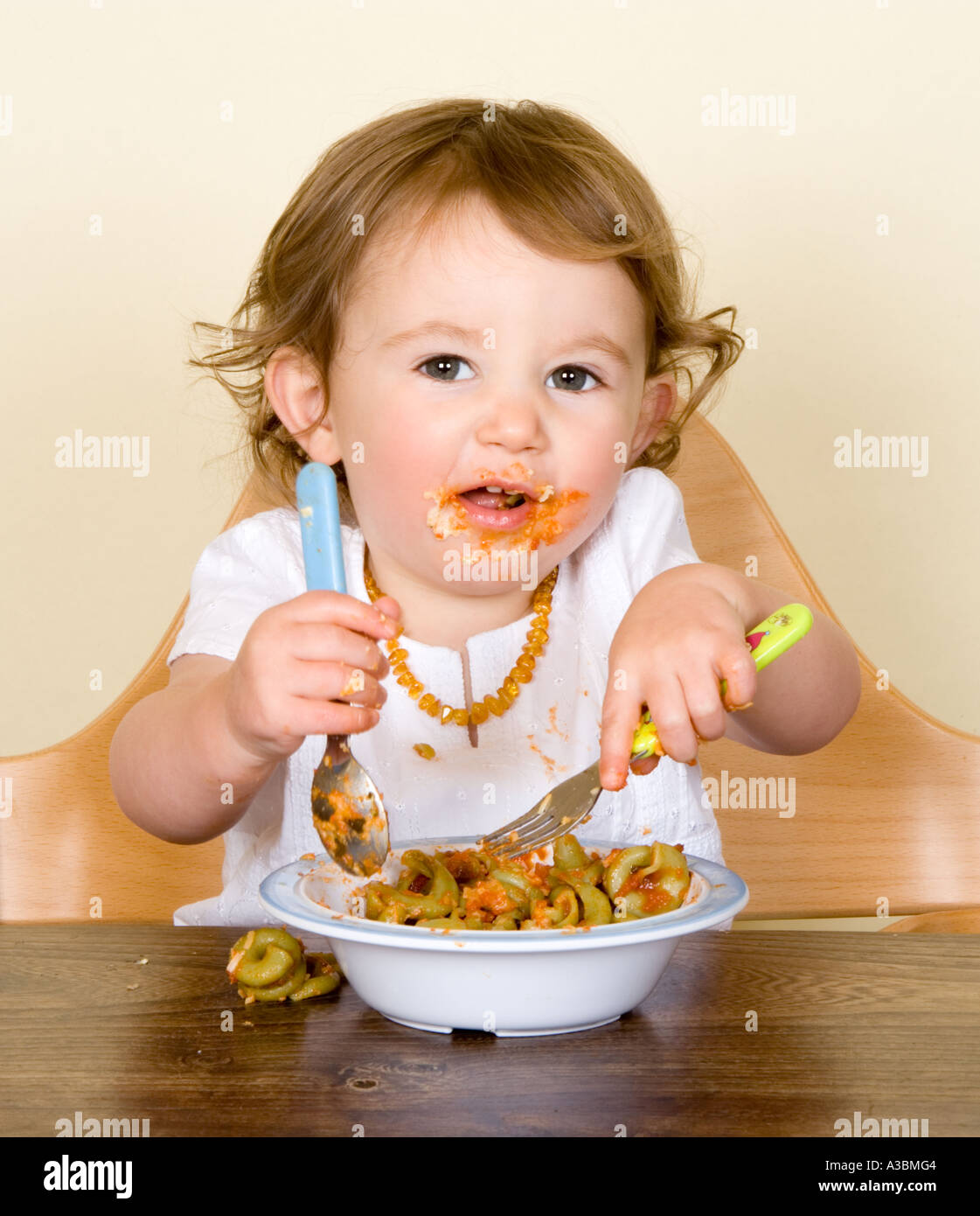 baby eating in high chair