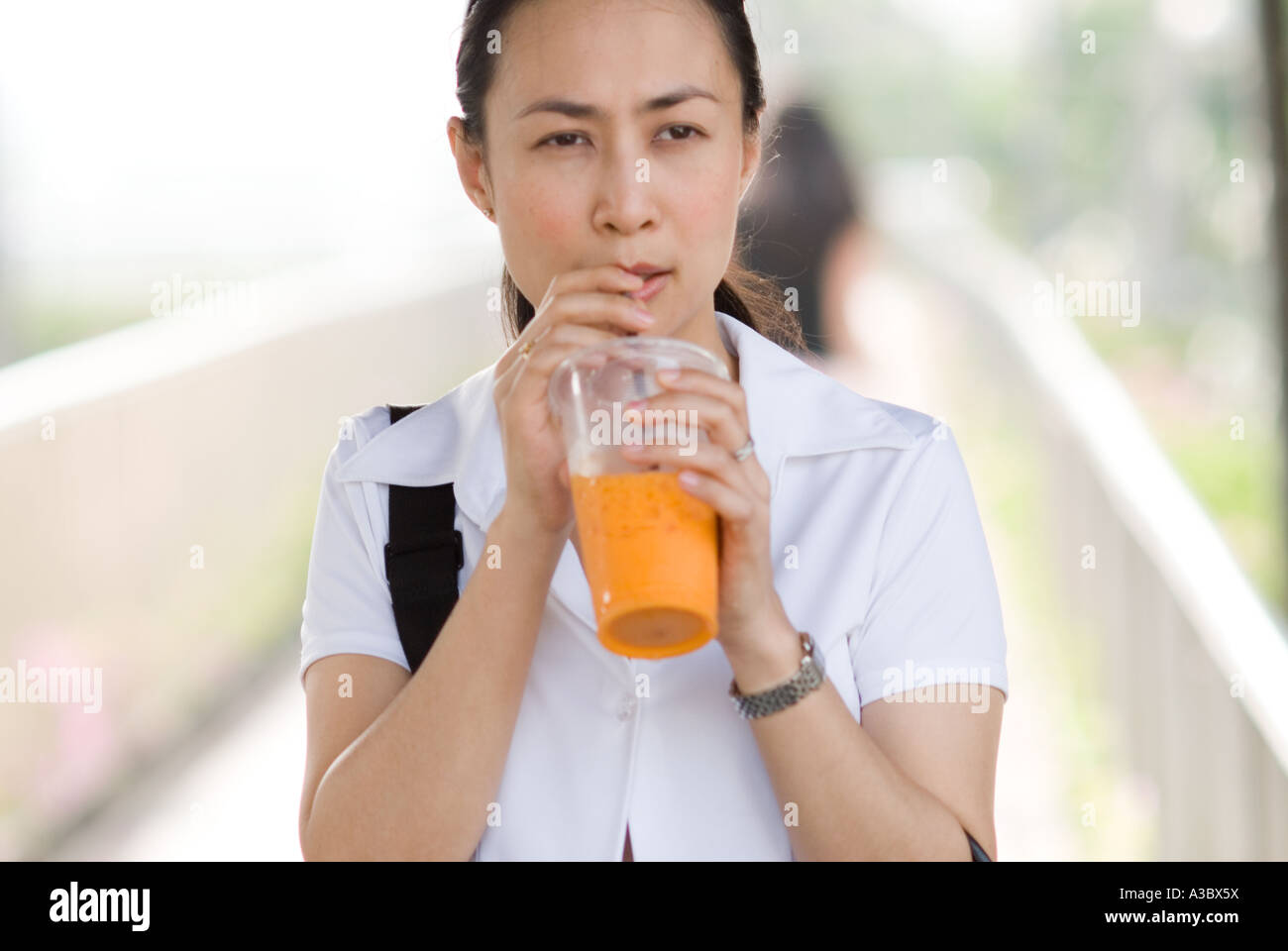 Young Thai businesswoman commutes to work in Bangkok, Thailand Stock Photo