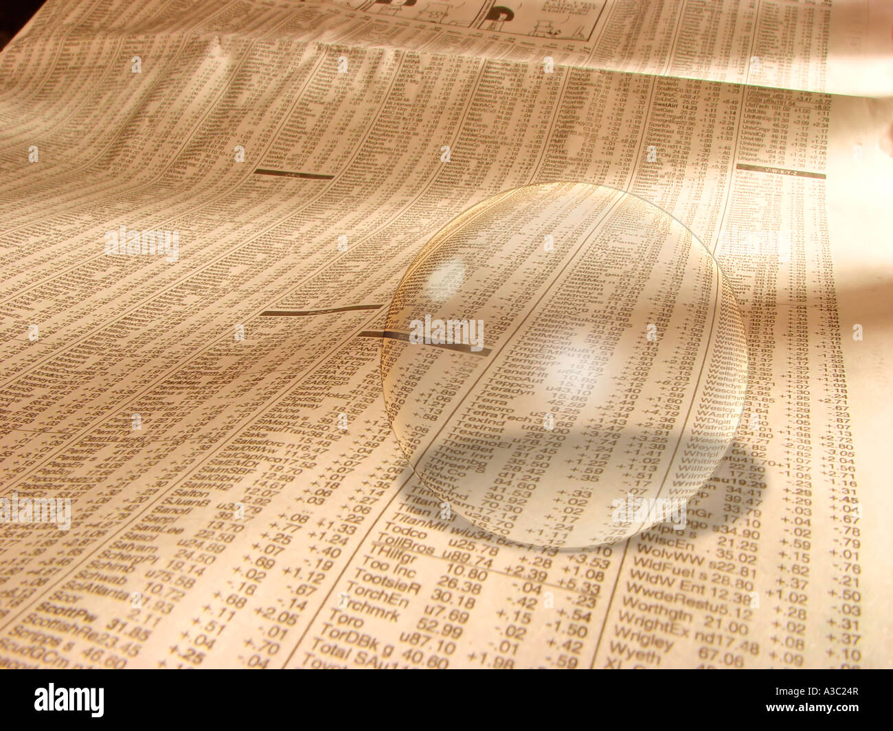 A glass ball on the financial page of a newspaper Stock Photo