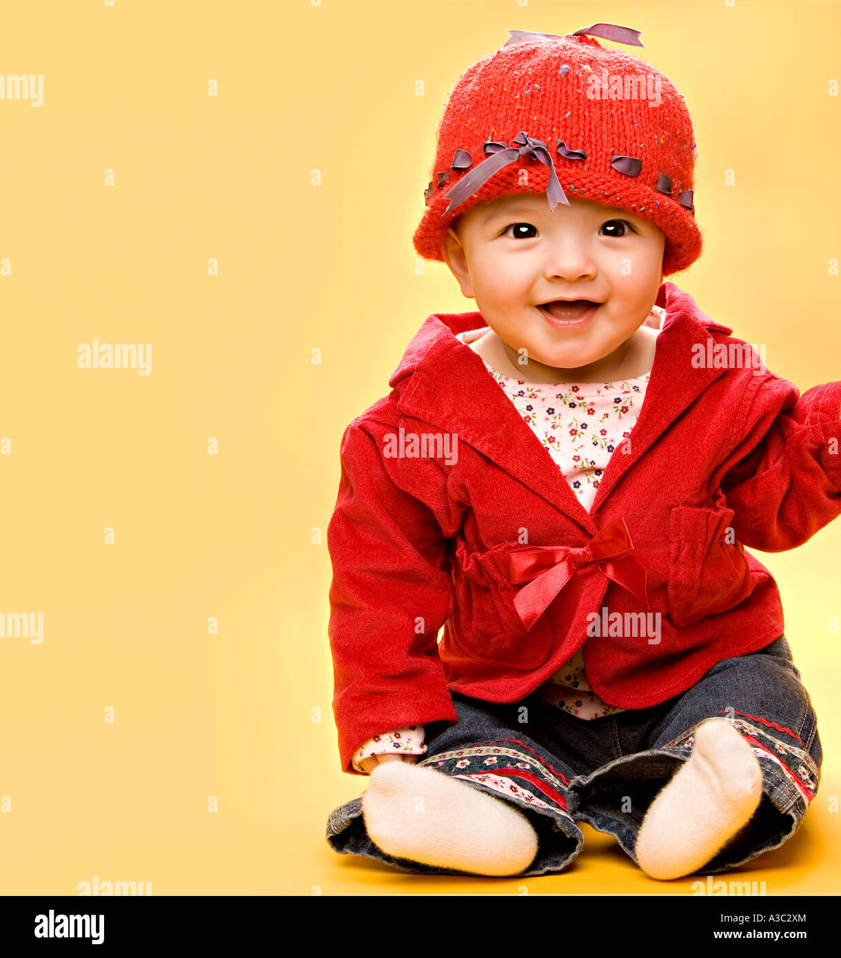 Baby in red outfit with red hat Stock Photo Alamy