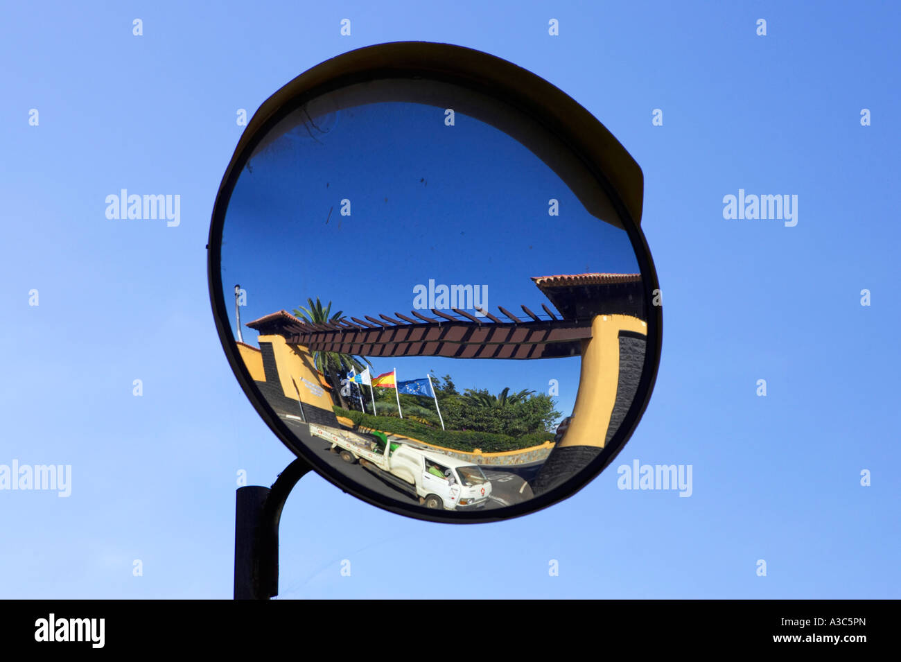convex security mirror used as a driving and traffic aid opposite and