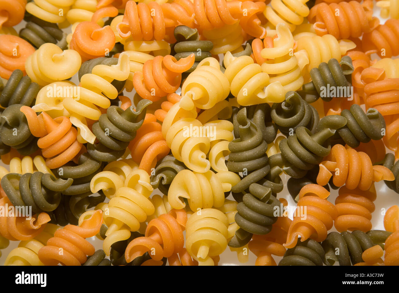 Pasta trottole shapes made from durum wheat tomato and spinach Stock