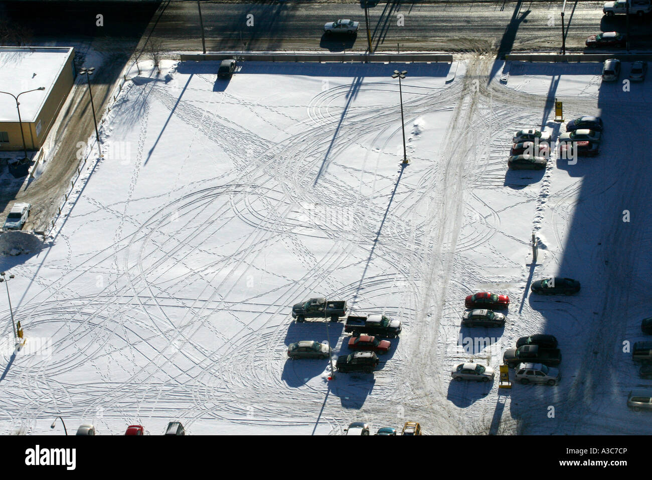 Car tracks in the snow in a parking lot. View from above Stock Photo ...