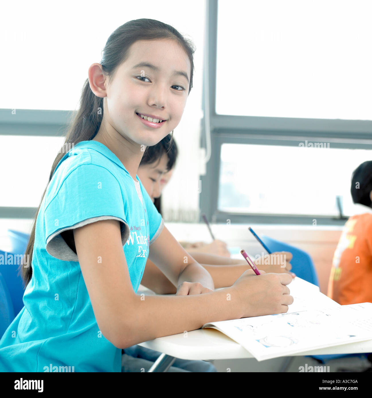 A girl smiling in the class Stock Photo - Alamy
