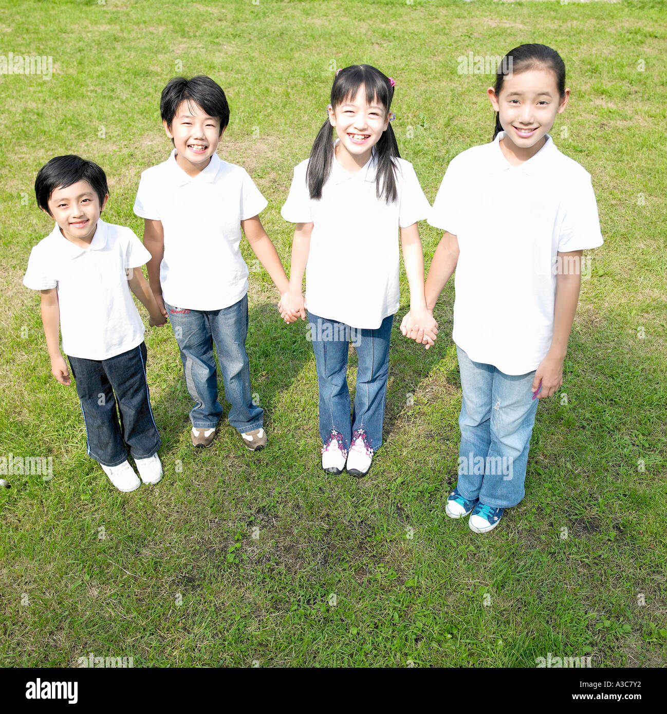 Many hands holding school hi-res stock photography and images - Alamy