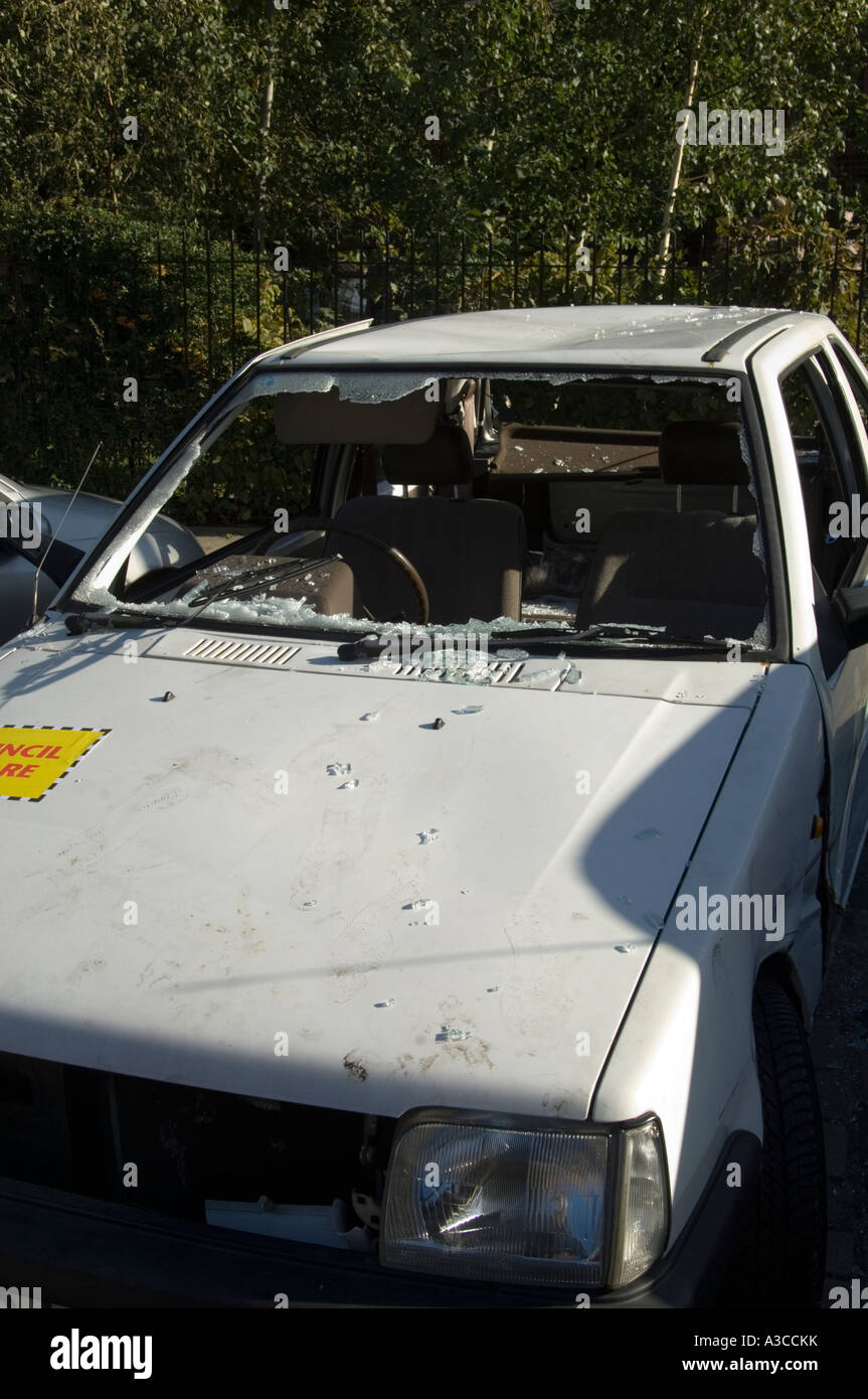 old white car wrecked and broken into with window smashed london england uk Stock Photo