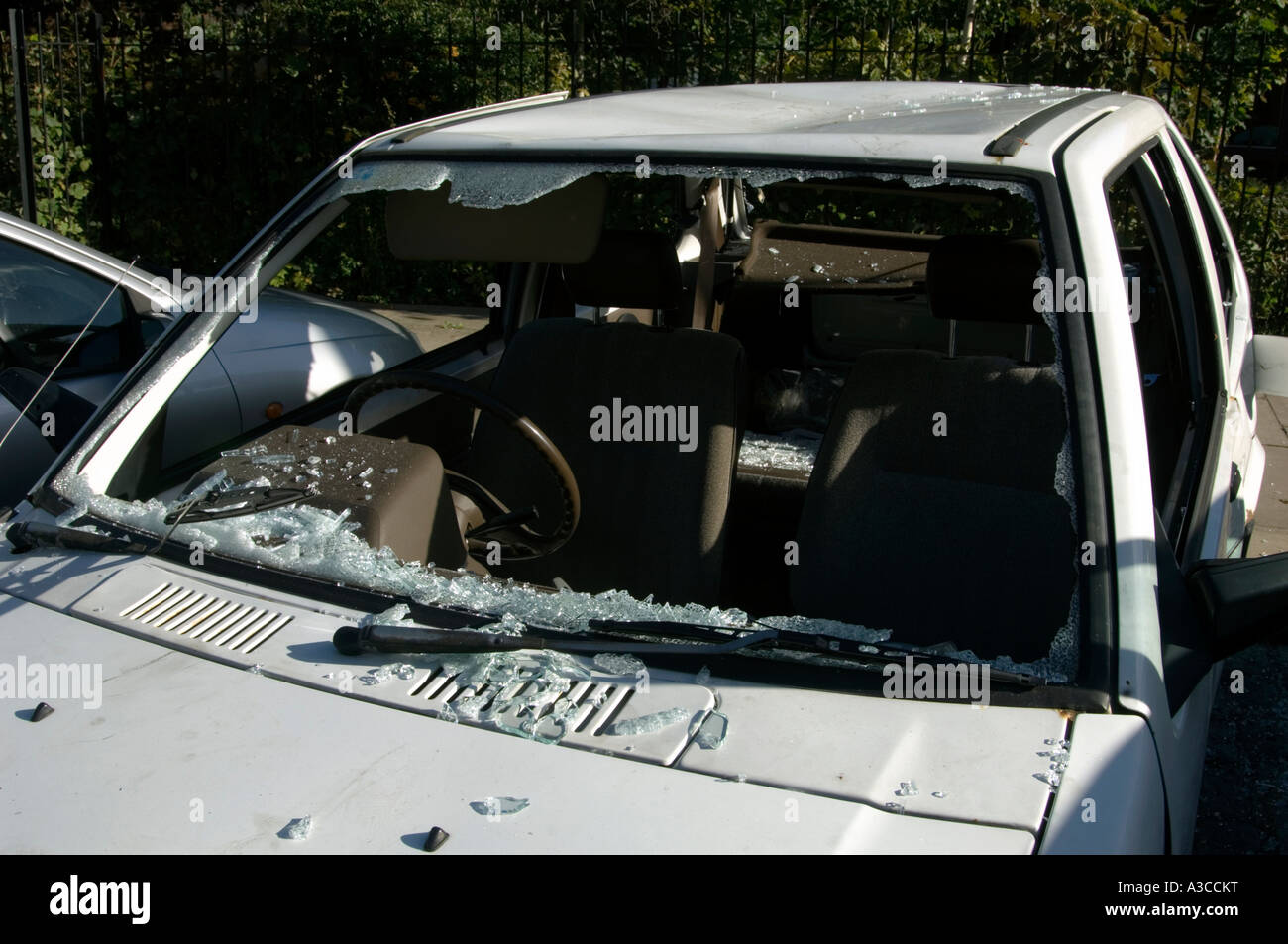 old white car wrecked and broken into with window smashed london england uk Stock Photo
