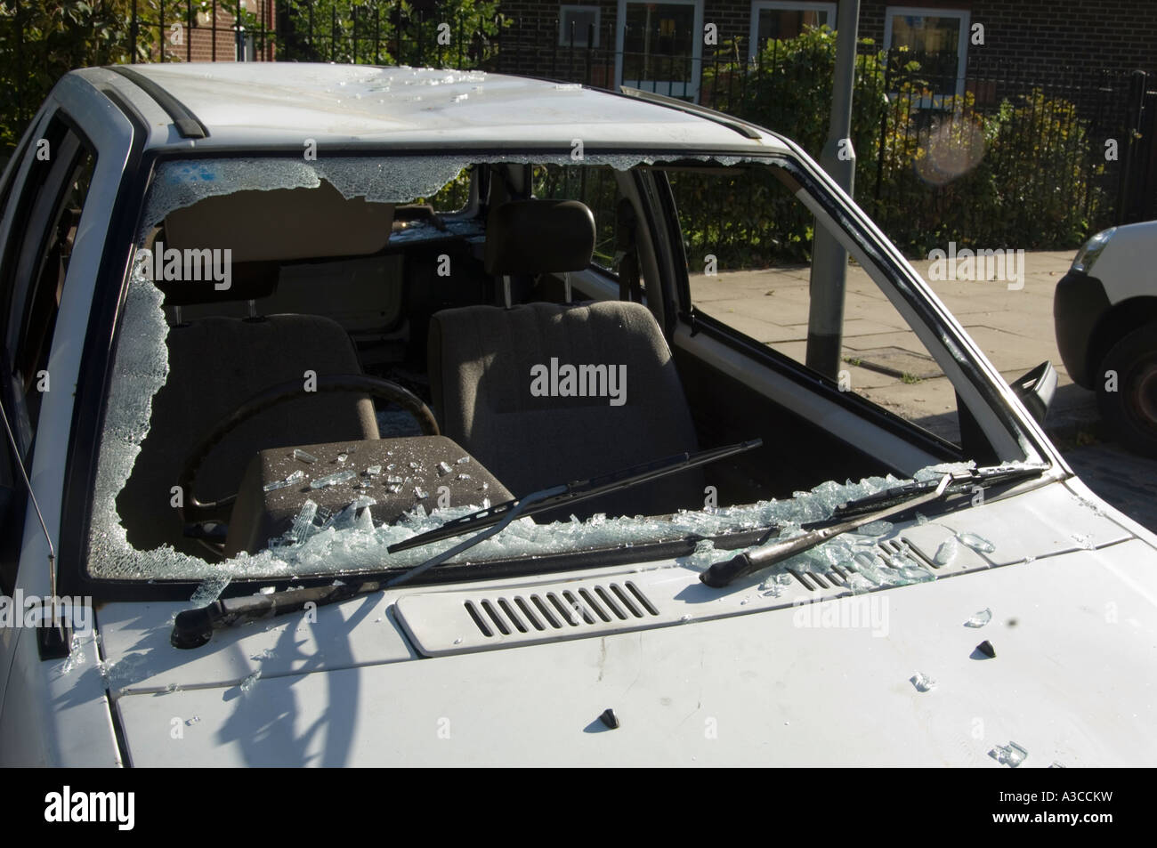 old white car; wrecked and broken into; with window smashed; london; england; uk Stock Photo