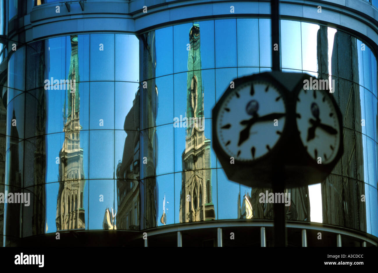 Part of St Stephen's Cathedral in Vienna is reflected in the modern Haas Haus across the street Stock Photo