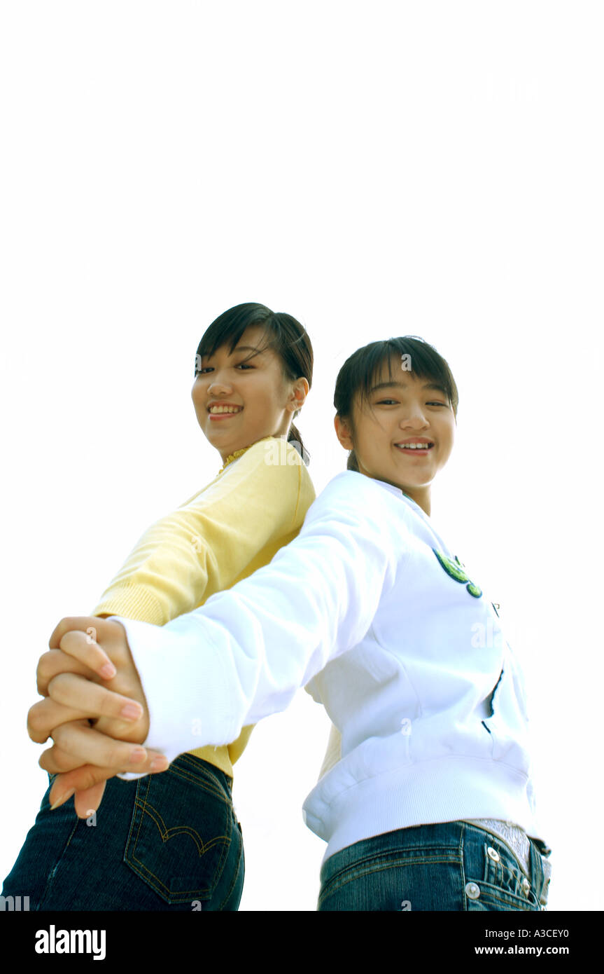 two female teenagers are locking their hands together Stock Photo Alamy
