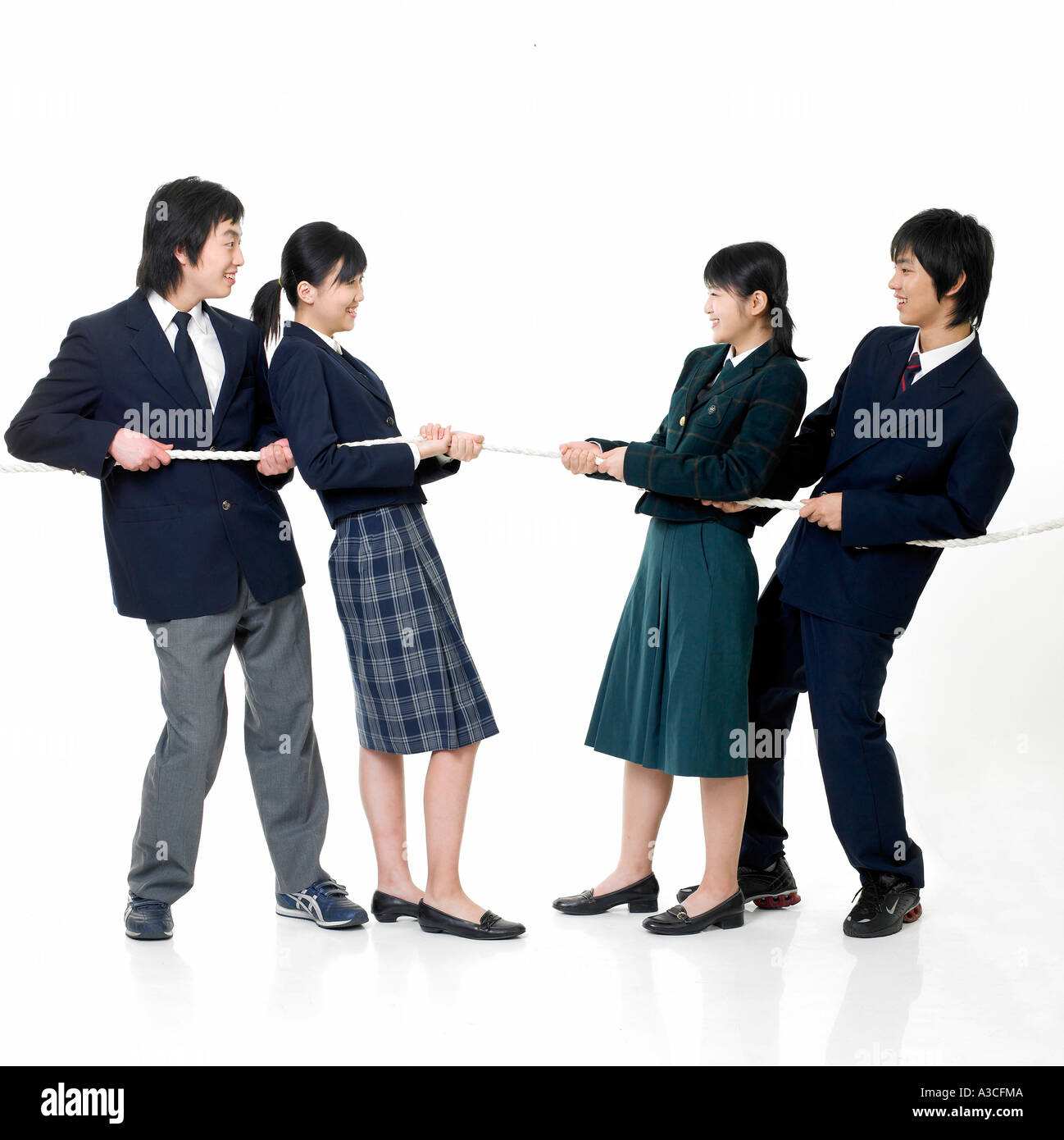 Four students are playing a rope pulling contest Stock Photo Alamy