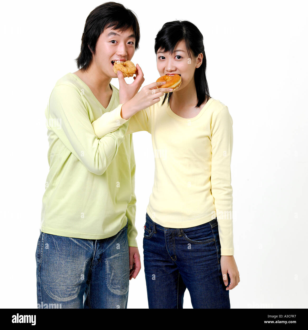 Teens sharing donuts Stock Photo