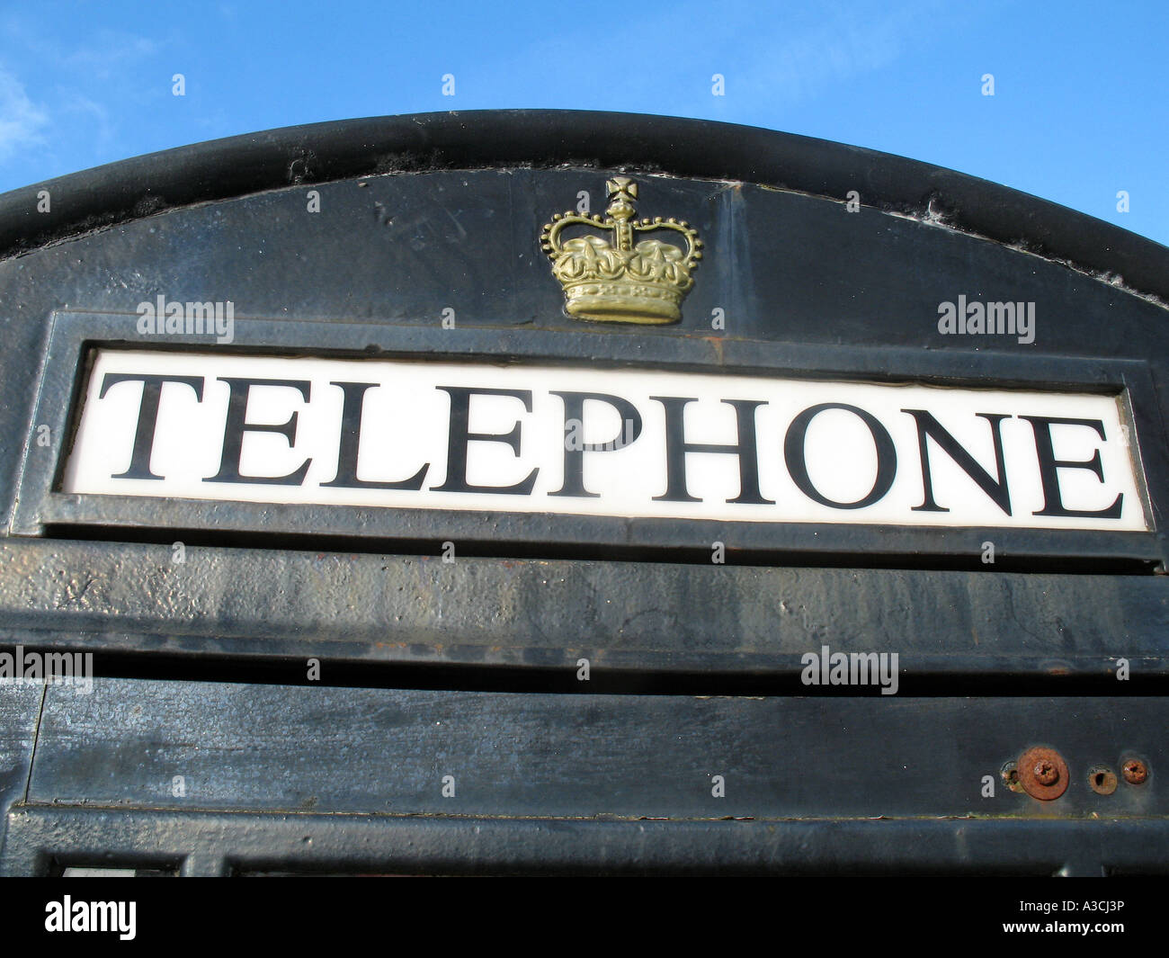 Telephone box painted black and gold Camborne Cornwall UK Stock Photo