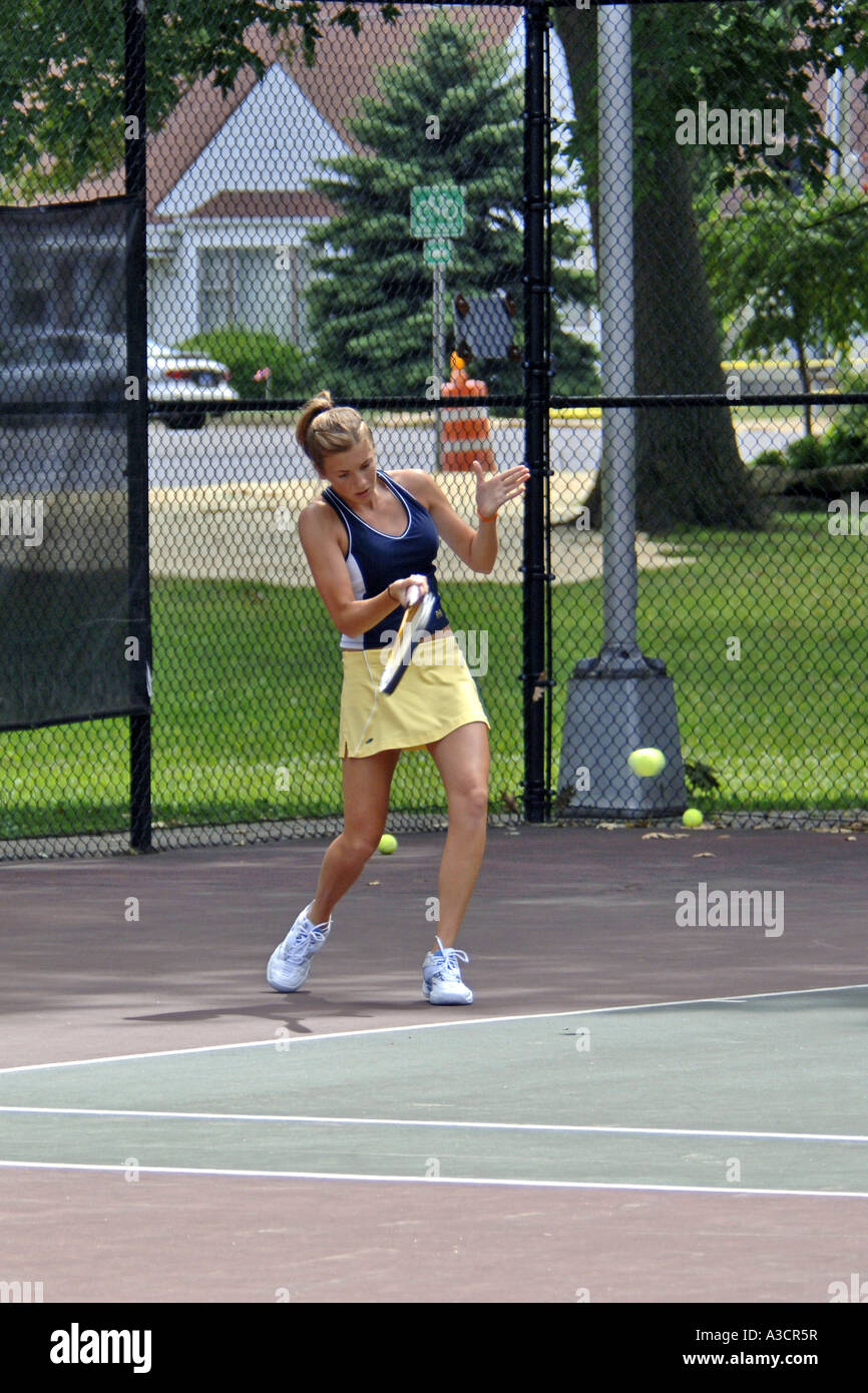 Teenage female playing at a High School tennis game in Michigan Stock