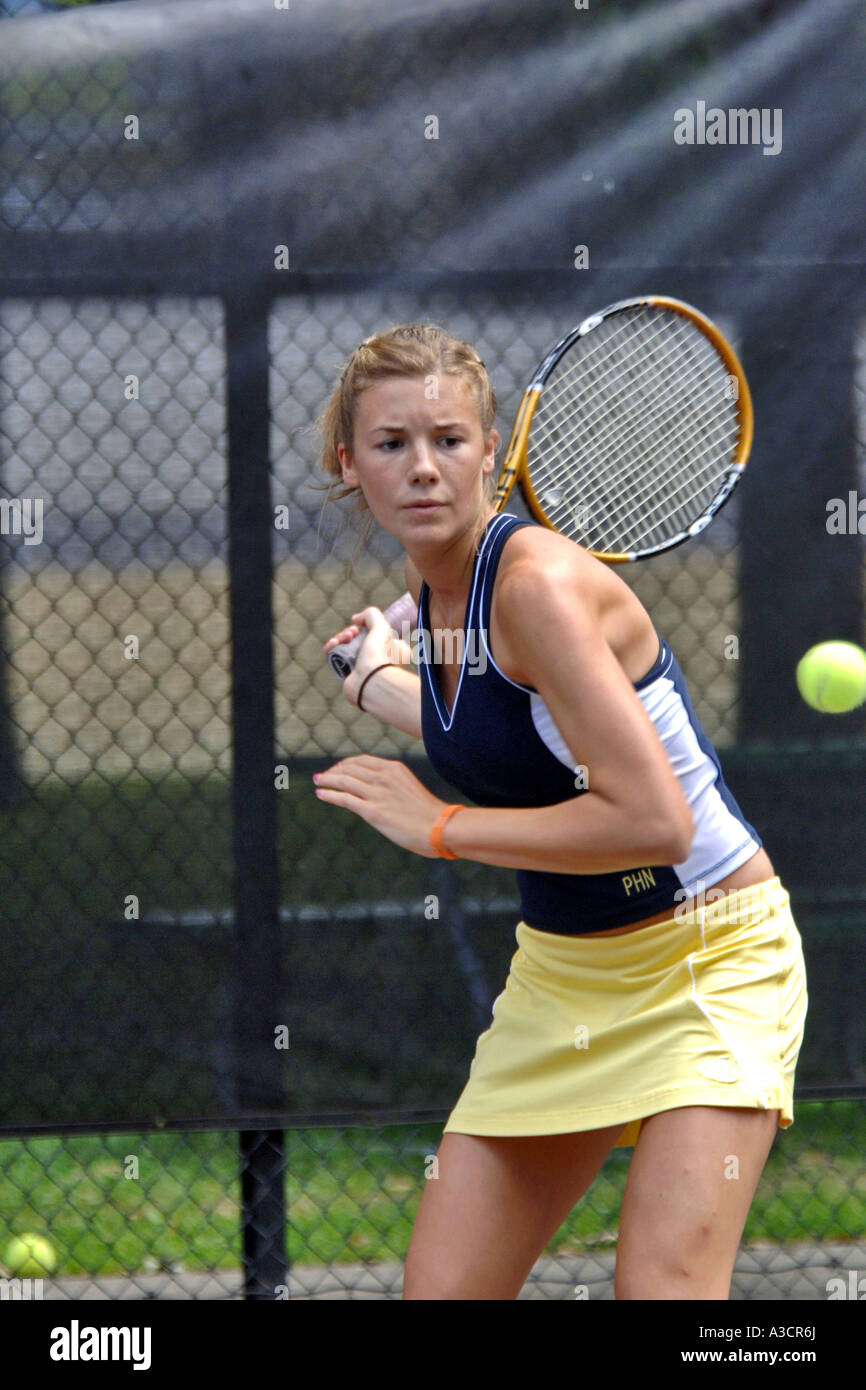 Teenage female playing at a High School tennis game in Michigan Stock