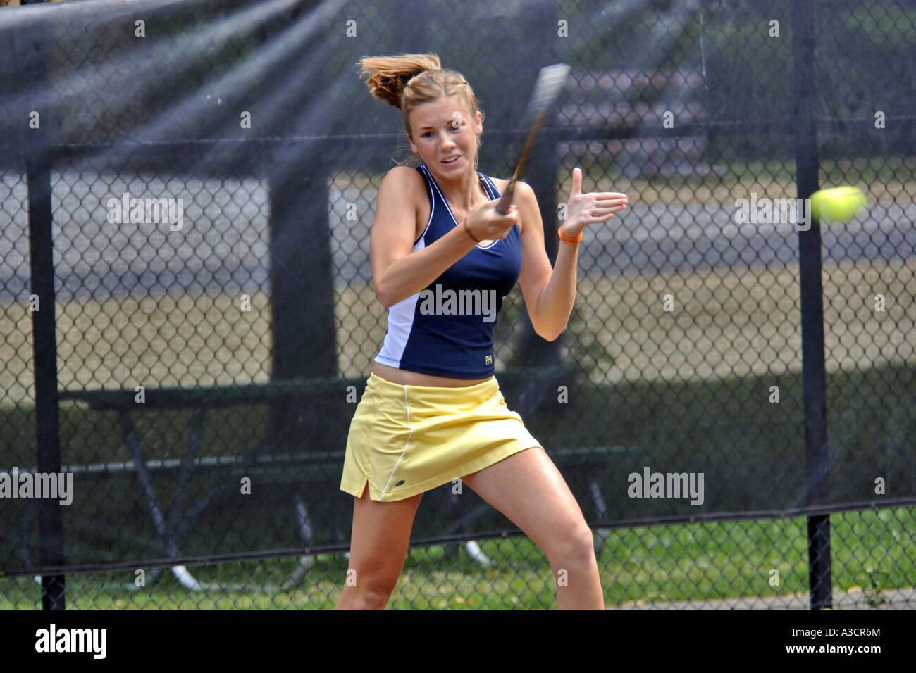 Teenage female playing at a High School tennis game in Michigan Stock Photo Alamy