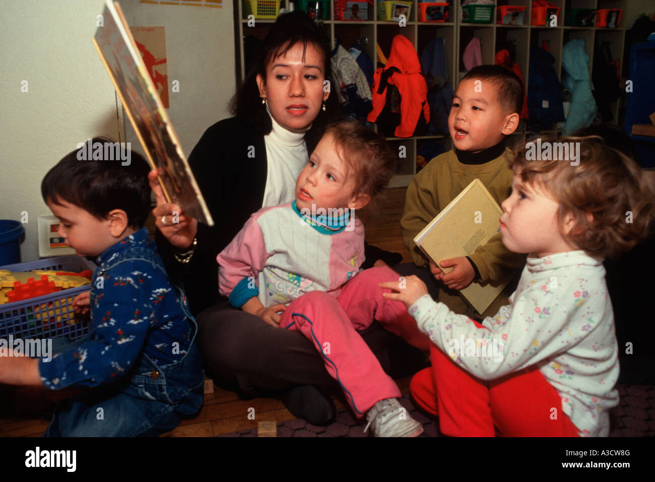 Nursery School Teacher Reads A Story To A Group Of Children At Free Stock Photo Alamy