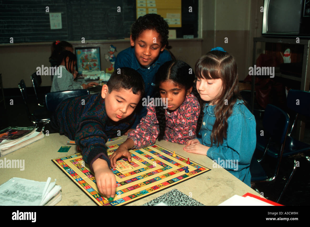 Kindergarten children playing a board game at a Brooklyn New York public school Stock Photo