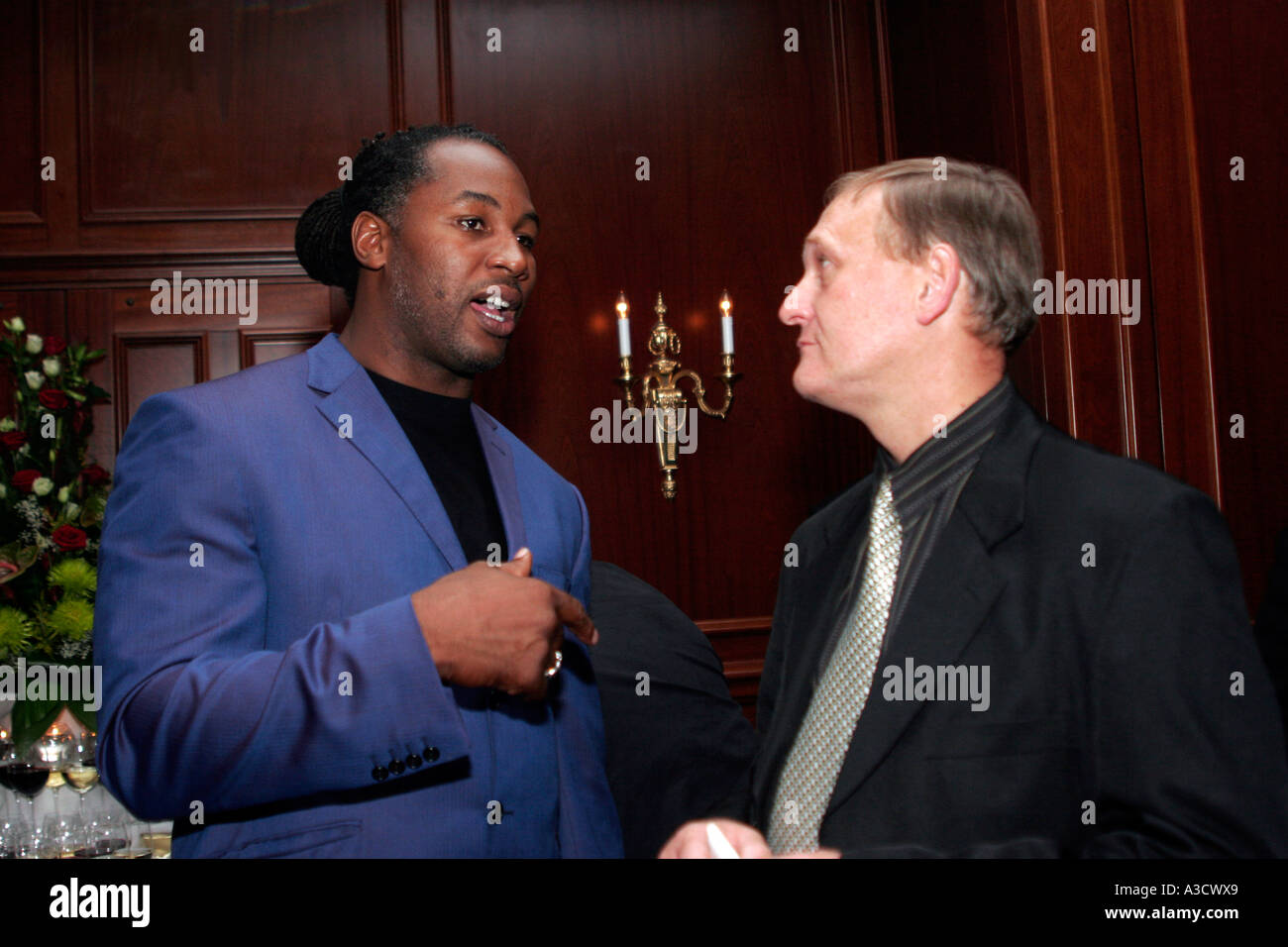 Lennox Lewis at cocktail in Kiev Premier Palace hotel with Belgian boxing ref Daniel Van der Wiele discuss Lennox' sudden KO loss to Rakhman in 2001 Stock Photo