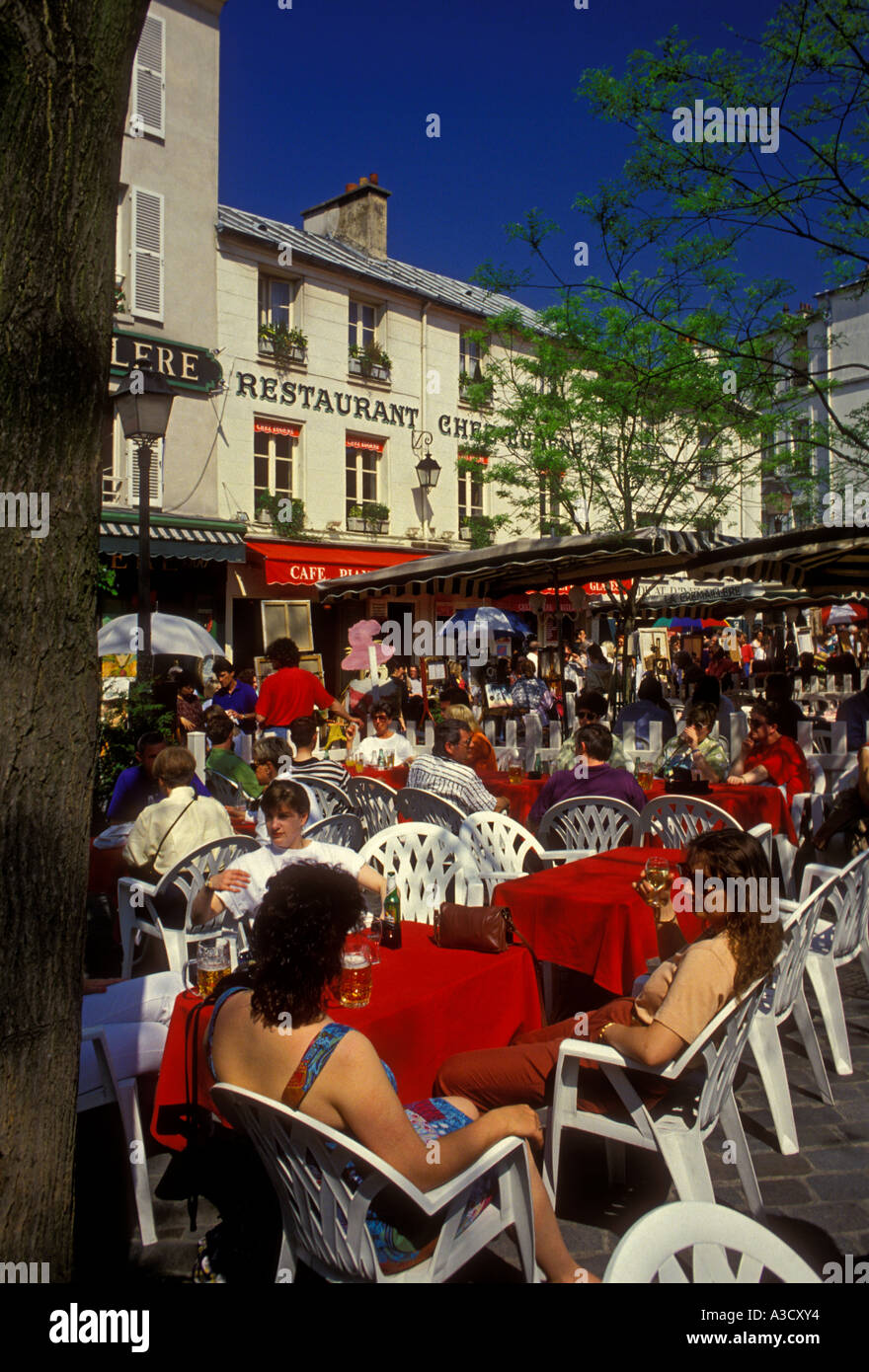 French people tourists eating at outdoor restaurant outdoor cafe in Place du Tertre in Montmartre District in Paris, Ile-de-France, France, Europe Stock Photo