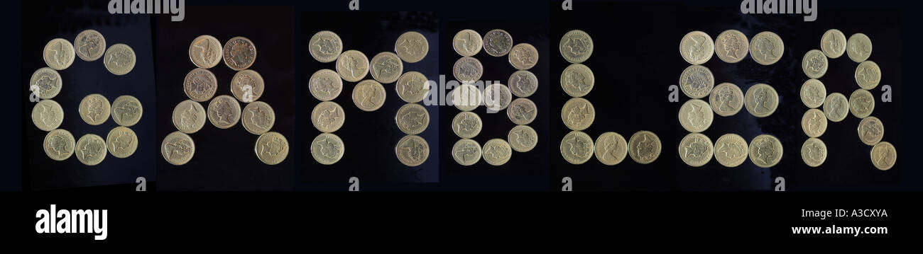 BRITISH POUND COINS forming the word GAMBLER  in capitals ON BLACK Stock Photo