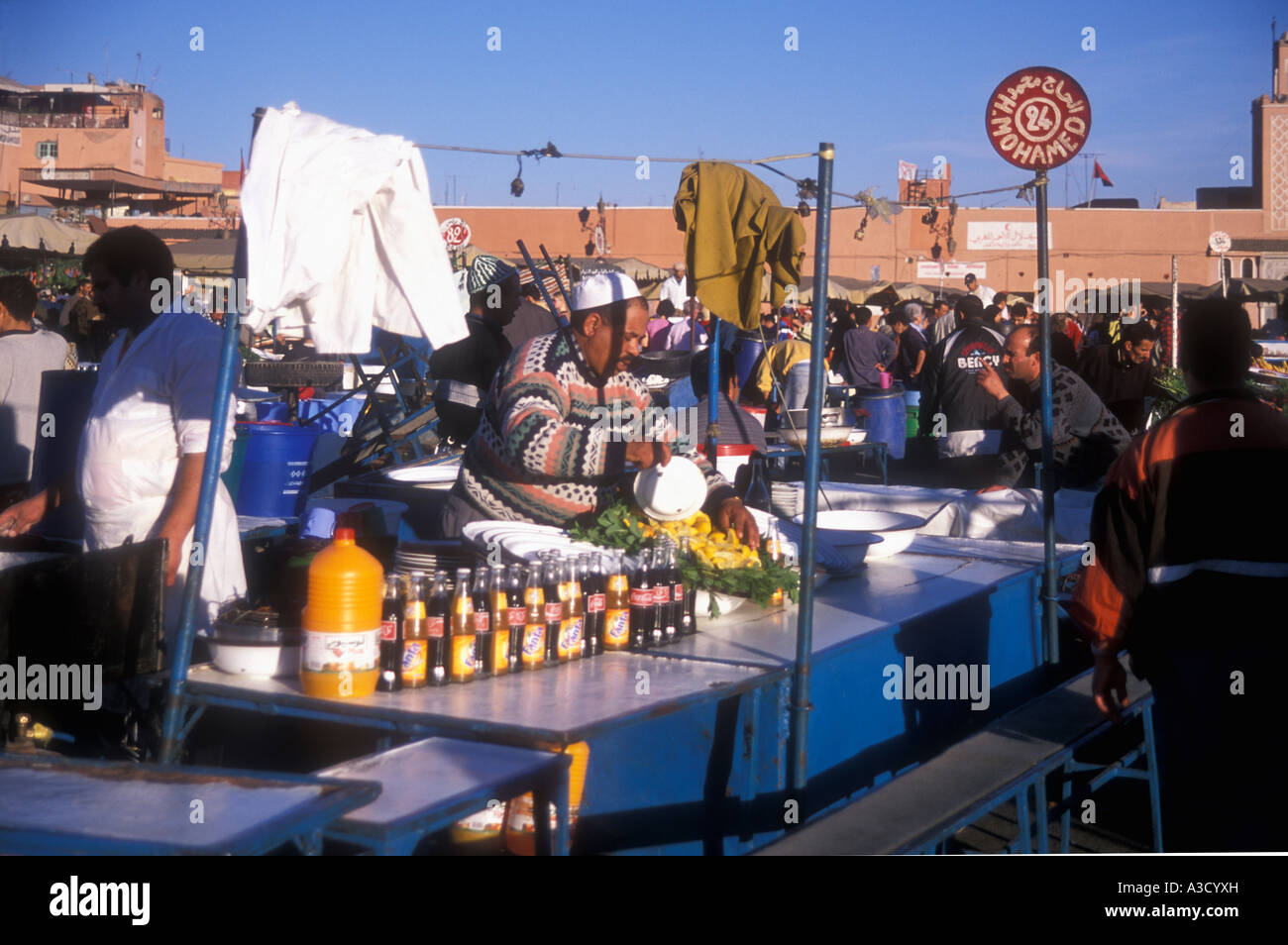Fruit drink stall at the bustling market at Place Djemaa el Fna Marrakesh Morocco Stock Photo