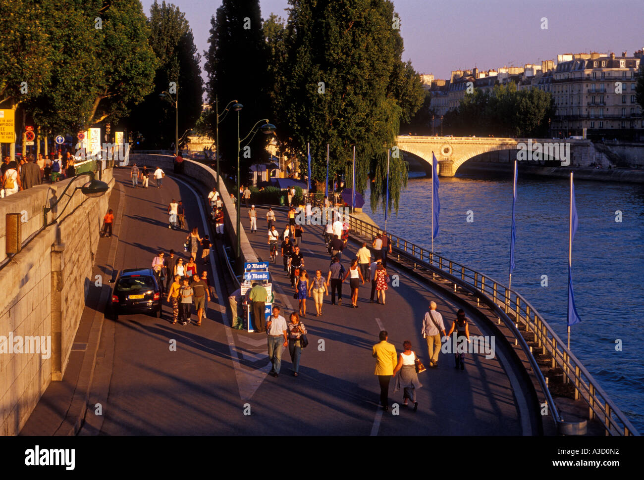 French people tourists walking along quai right bank of Seine River Paris Ile-de-France region France Europe Stock Photo