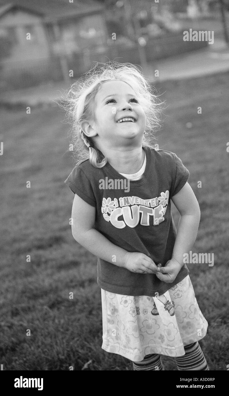 little girl smiling and looking into the sky Stock Photo - Alamy