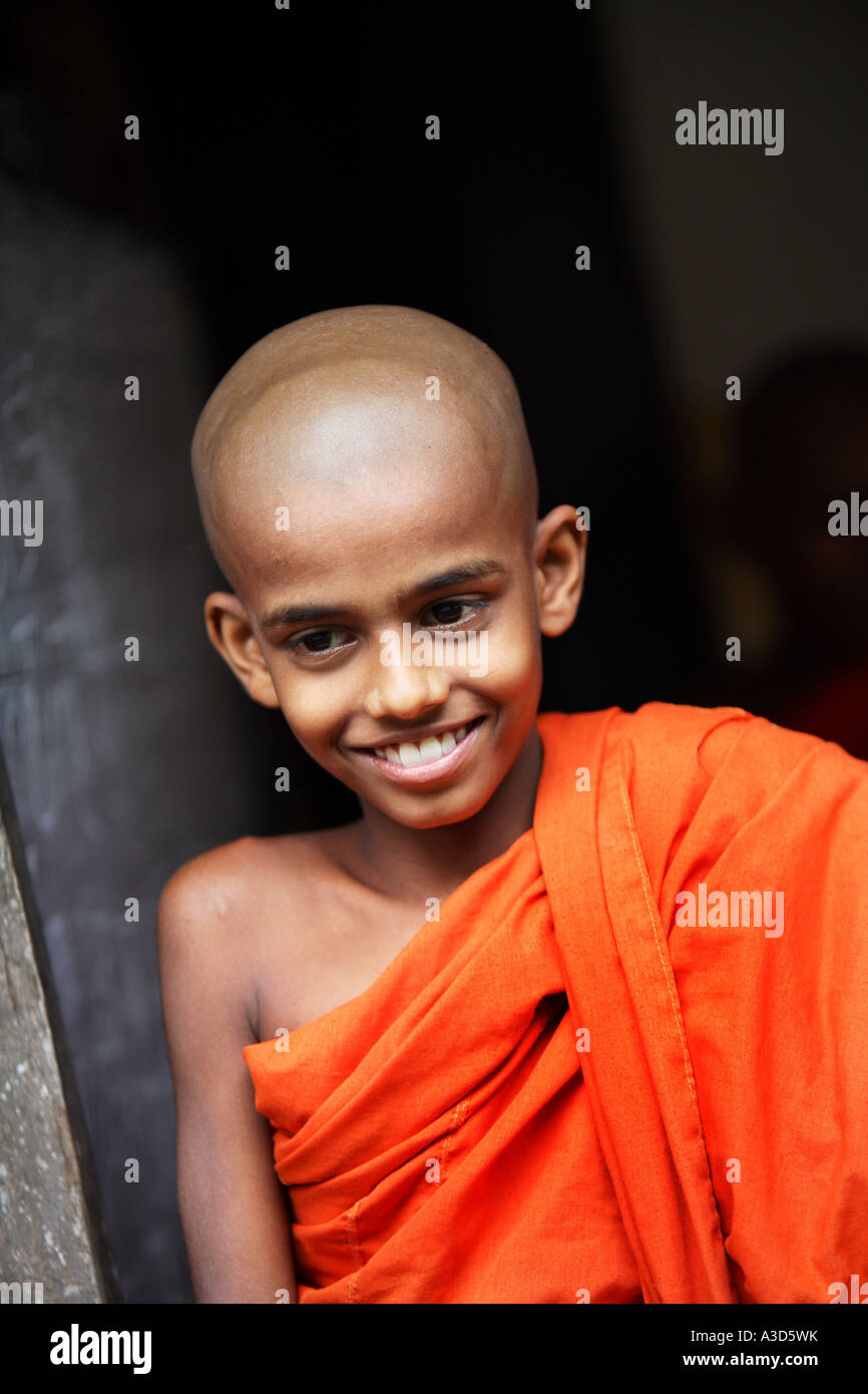 Vertical close up portrait of young student Buddhist monk in school