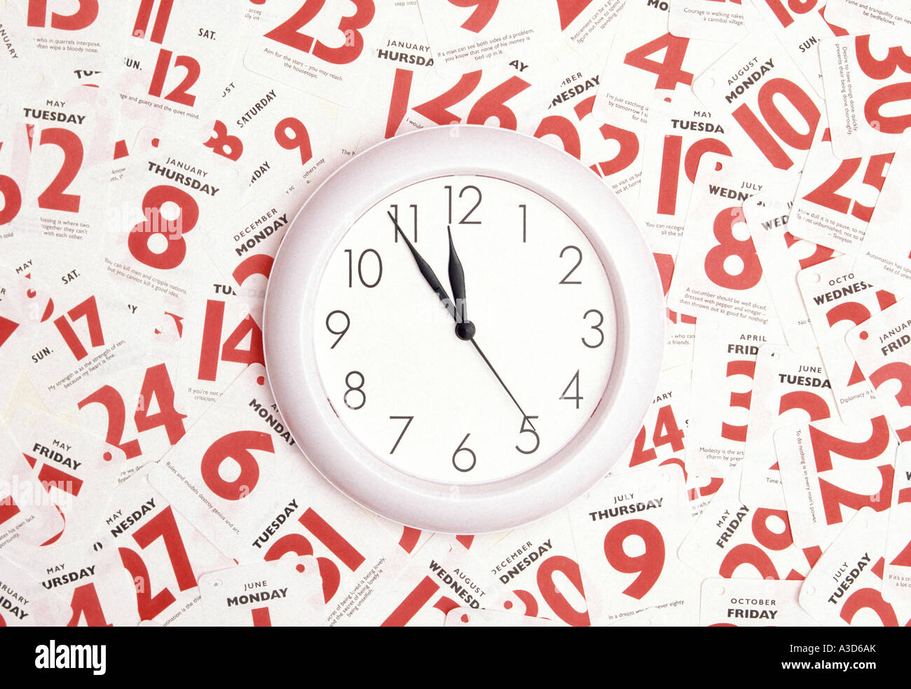 Time date calendar appointment conceptual image using clock face & red dates of week month & year as concept for people who try to manage a busy life Stock Photo