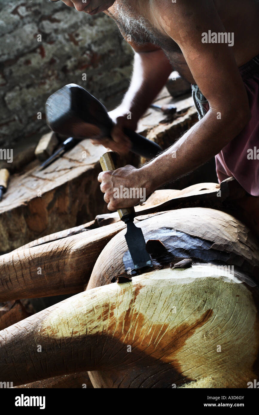 Elephant Chisel Environmental portrait of wood carver with hammer and chisel, making ...