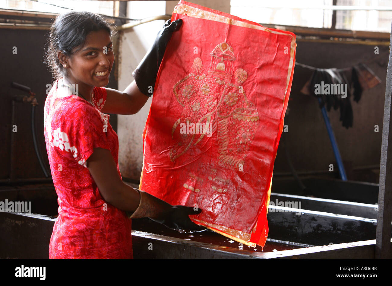 Local woman in batik factory, Kandy, Sri Lanka, dyeing material with