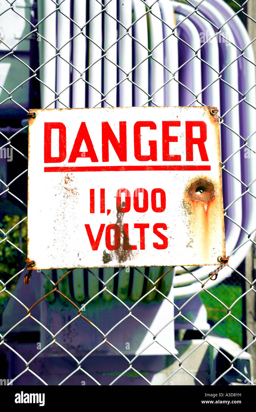 High voltage warning sign on fence Stock Photo