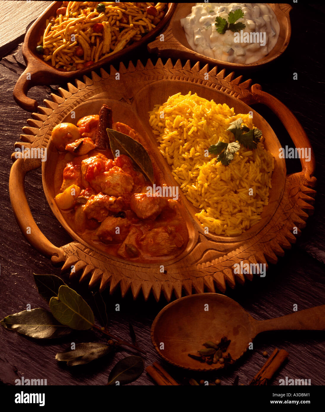 chicken vindaloo with pilau rice and raita Stock Photo - Alamy