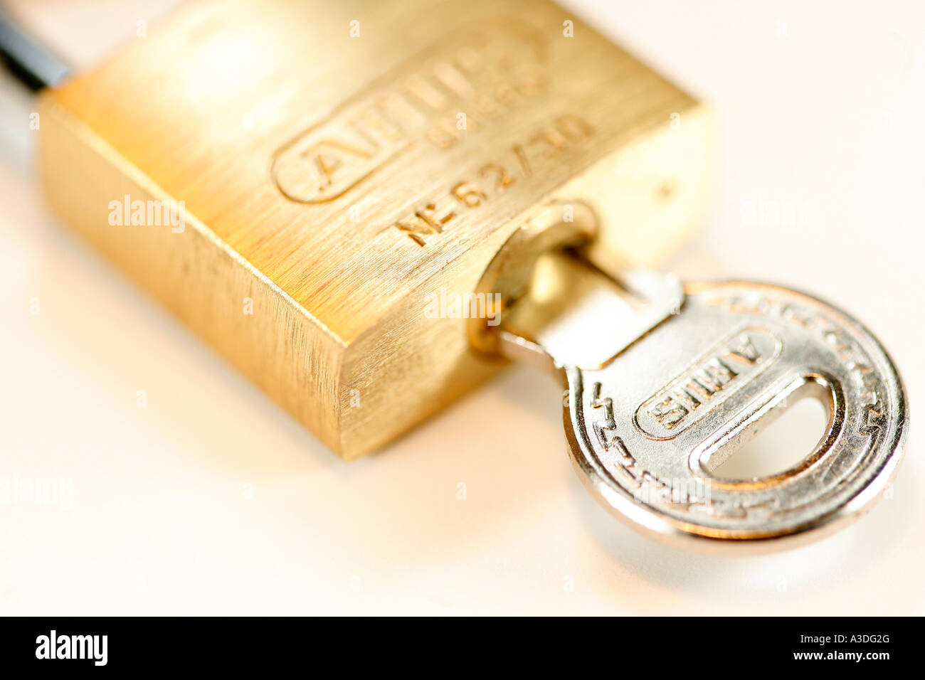 Key inside a closed safety lock Stock Photo Alamy